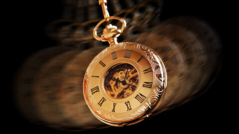 Hypnotism concept, gold pocket watch swinging used in hypnosis treatment